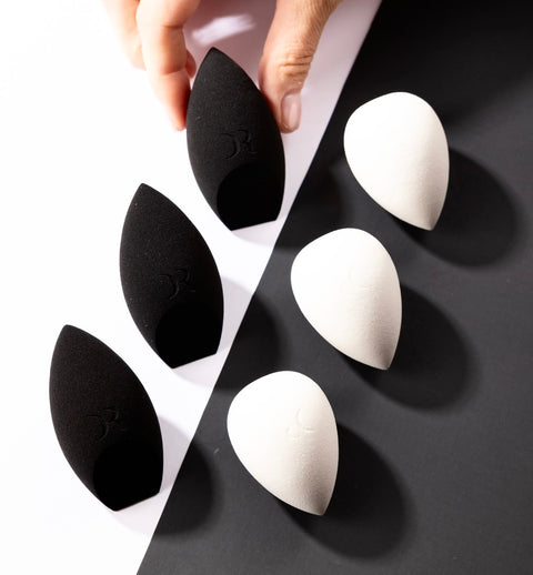Dorina Rotari black and white latex-free makeup sponges arranged on a modern flat lay