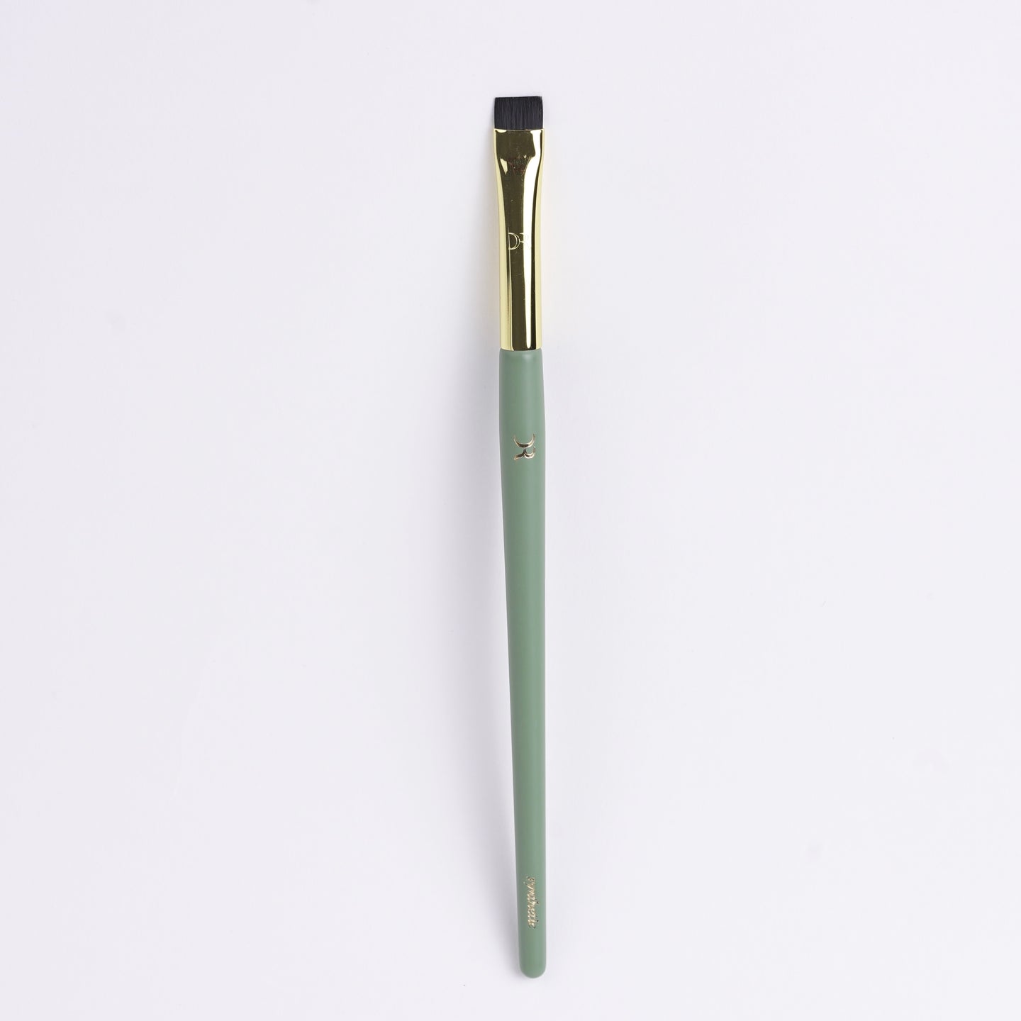 Flat-edge brush with sleek handle, perfect for detailed, controlled makeup application.