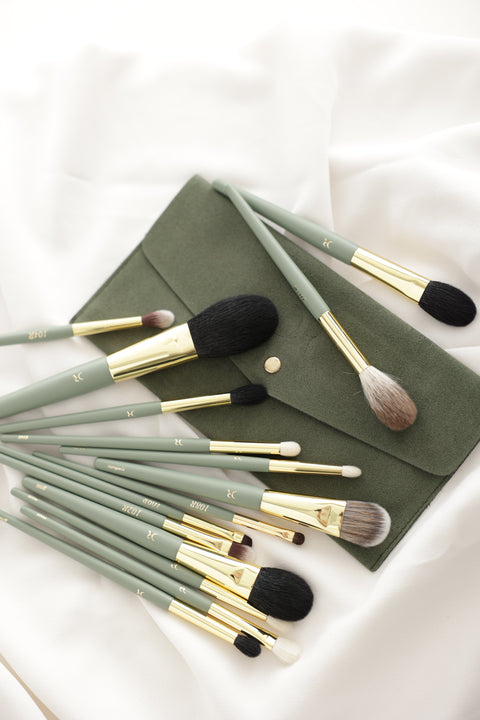 Dorina Rotari Pro-Create makeup brush set with green handles and travel pouch on white fabric
